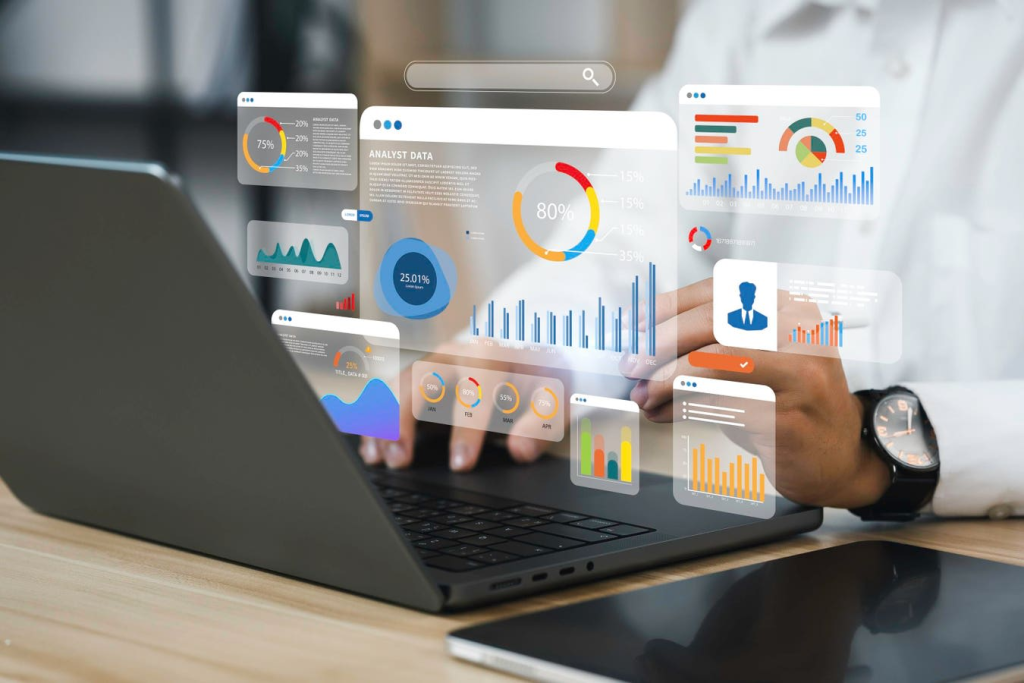 A person interacts with a laptop featuring holographic digital interfaces displaying business analytics, symbolizing the role of AI in data-driven decision-making