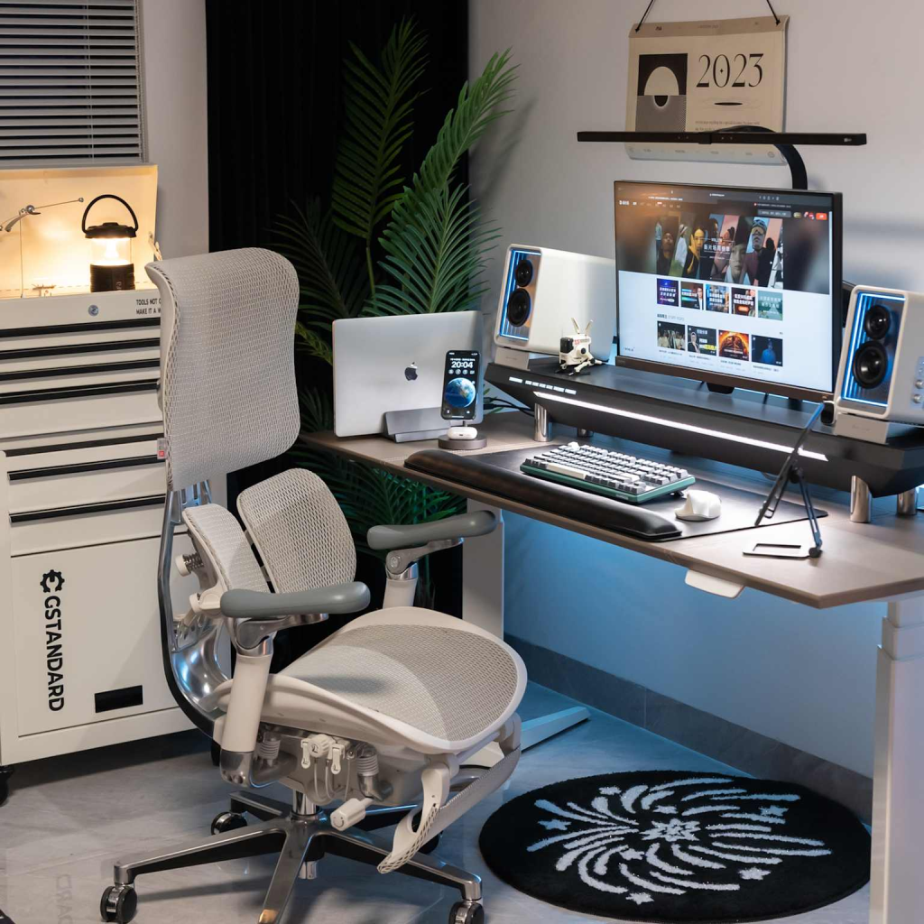A modern and well-equipped home office setup featuring a computer, monitor, and ergonomic chair, ideal for producing professional video content